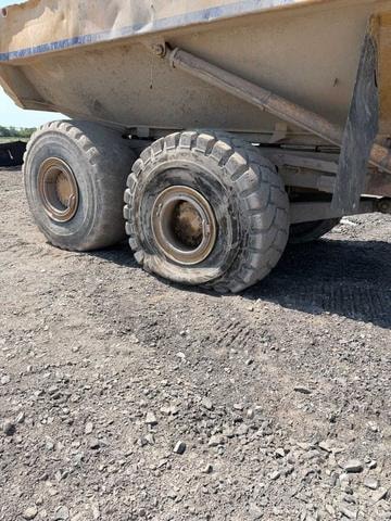 Articulated dump truck flat tire on a job site
