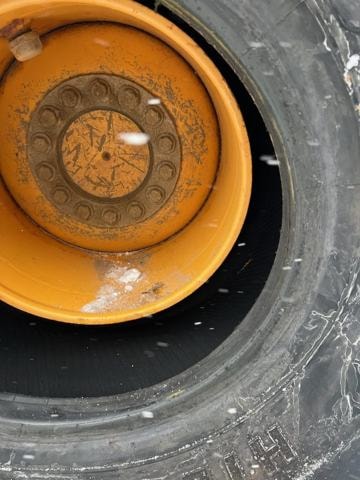 Wheel loader rim and tire close-up during on-site service